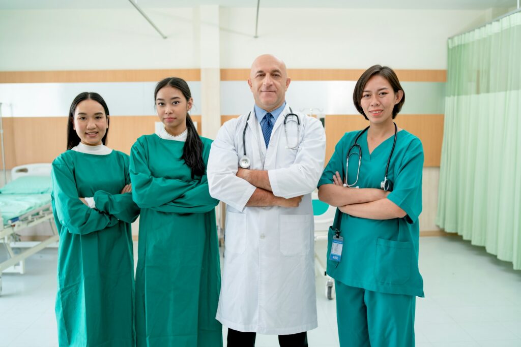 Portrait of doctor and nurse stand with arm crossed or confidence action in patient care room